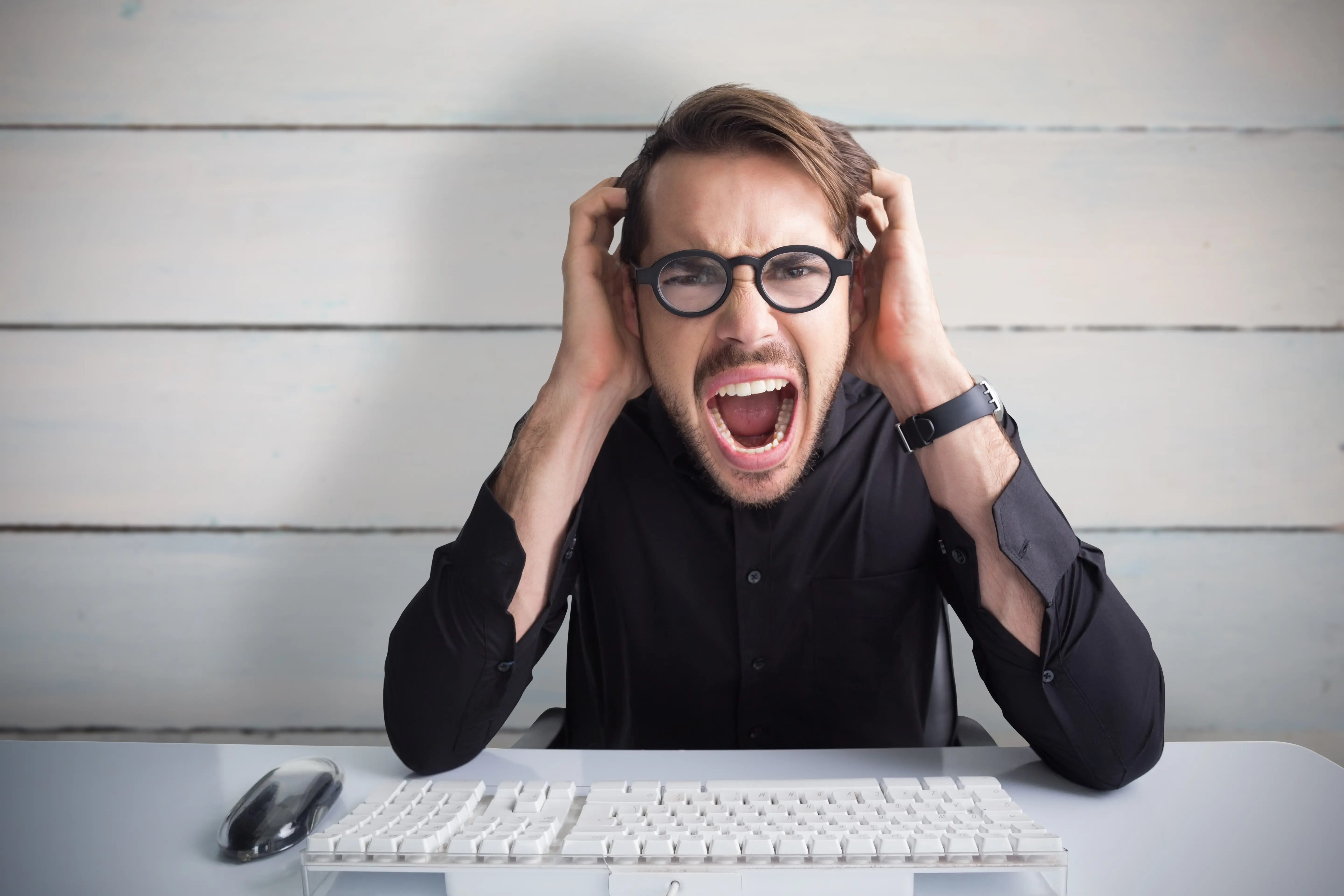 Businessman yelling with his hands on face against painted blue wooden planks