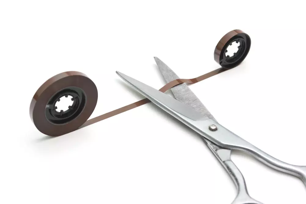 audio tape and scissors isolated on a white background